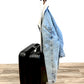 Hanger with Coat on Back of Luggage